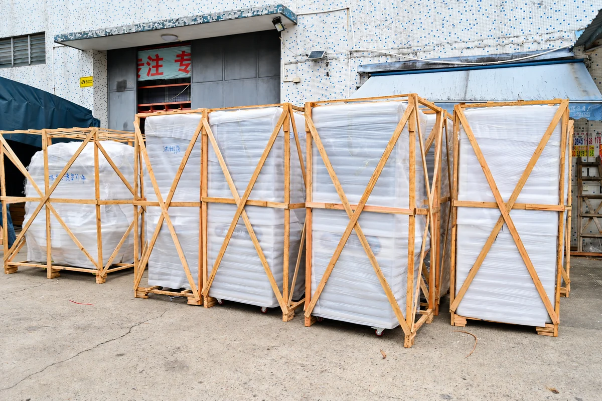 Commercial arcade machines protected in wooden export frames before international shipping